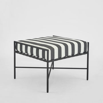 Sheffield outdoor ottoman with black and white striped cushion powder coated steel frame and weather resistant fabric for modern patio seating