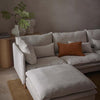 Aura upholstered ottoman in natural Belgian linen with plush feather cushion and solid oak legs for luxury living room seating