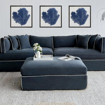 Modern navy ottoman with soft upholstered cushion and timber frame for stylish interior furniture design