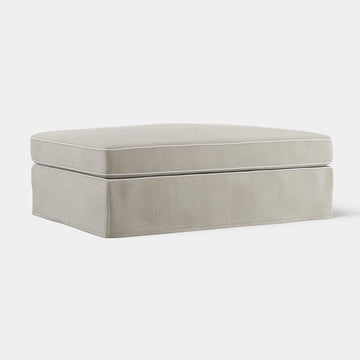 Marbella upholstered ottoman in natural fabric with white piping cushioned seat and timber legs for coastal style living room seating