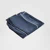 Hamptons style navy ottoman replacement slip cover with contrast white piping and relaxed skirt design