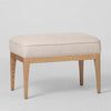 Asteria beige upholstered ottoman with padded seat linen blend fabric and solid ashwood legs for contemporary living room seating