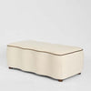 Avoca bedroom ottoman in ivory upholstered fabric with chocolate piping and cushioned seat for luxury bedroom styling