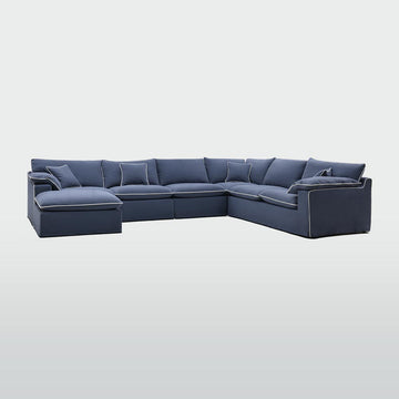 Modern modular ottoman with navy fabric upholstery and white piping for elegant living room and lounge seating