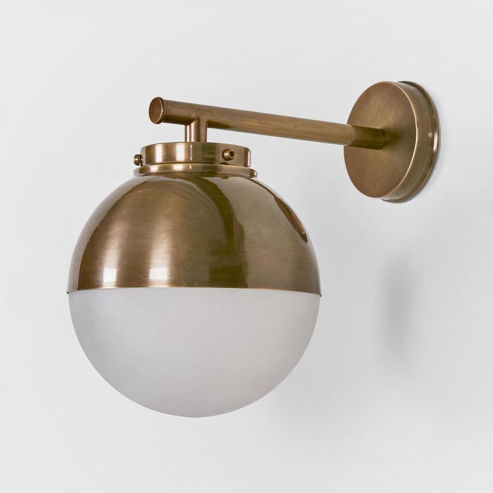 Carrington Outdoor Wall Light with black round backplate and half-glass half-brass globe – modern exterior wall sconce for entryways, patios, and commercial spaces