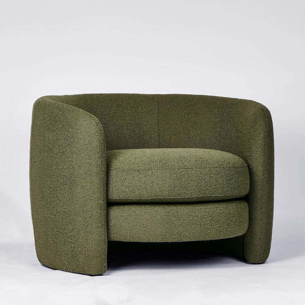 High-back curved armchair with boucle upholstery and modern design for living room or bedroom use