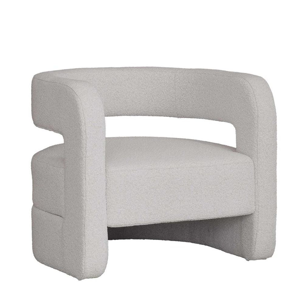 Upholstered curved armchair in boucle or corduroy fabric with sculptural circular silhouette