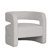 Upholstered curved armchair in boucle or corduroy fabric with sculptural circular silhouette