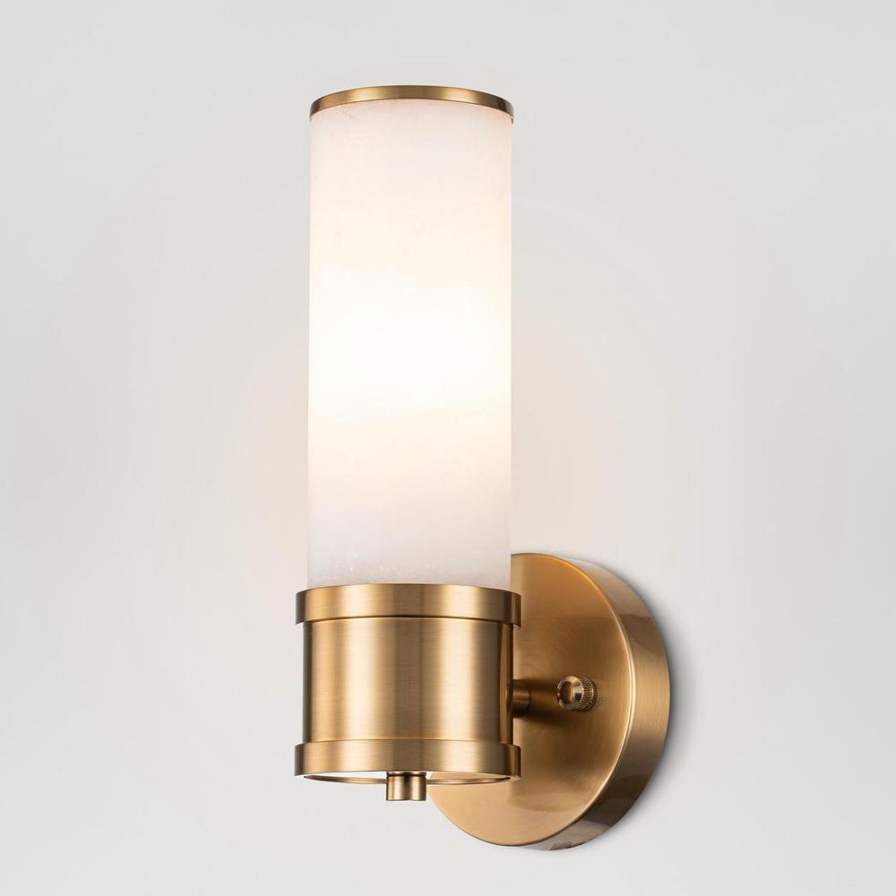 Herman Wall Light brass-finished frame with cylindrical glass shade – elegant modern wall sconce for hallways, bedrooms, and living spaces