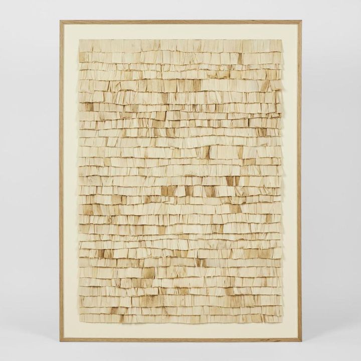 Large natural bark textured wall art with layered organic materials in neutral tones.