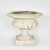 Decorative urn planter with footed base and stone-look finish for indoor and outdoor garden use