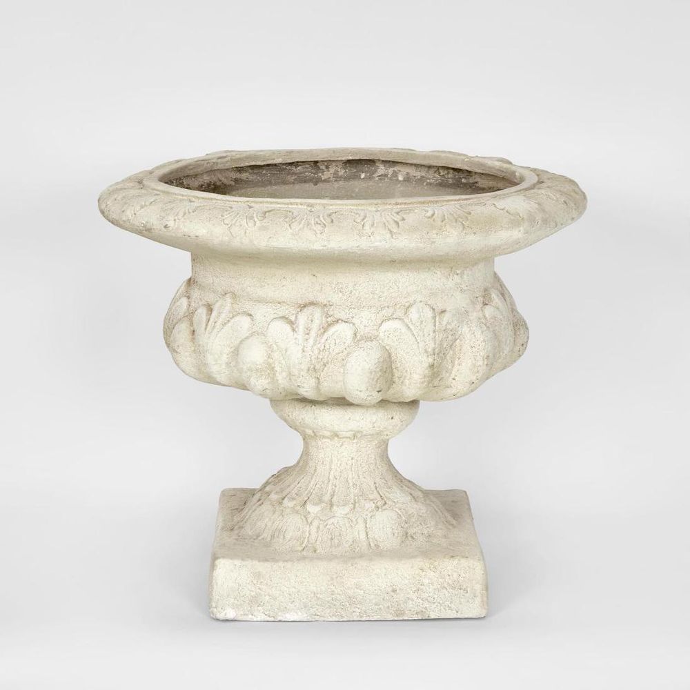 Decorative urn planter with footed base and stone-look finish for indoor and outdoor garden use