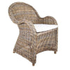 Long Island wicker armchair with handwoven rattan frame, rolled arms, and removable cushion in coastal Hamptons style