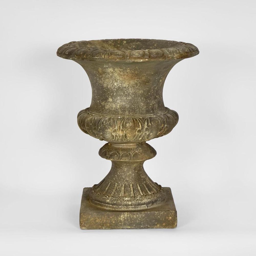 Decorative arbor urn planter with stone-look finish and footed base for garden or patio use