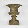 Decorative arbor urn planter with stone-look finish and footed base for garden or patio use