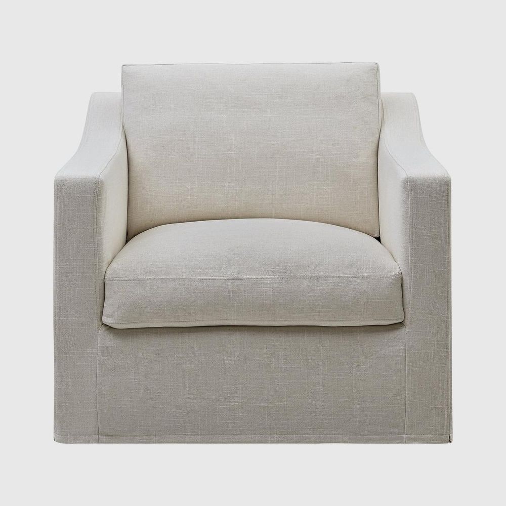 Elegant Hamptons style upholstered armchair with soft slipcover, comfortable cushions, and traditional coastal-inspired design