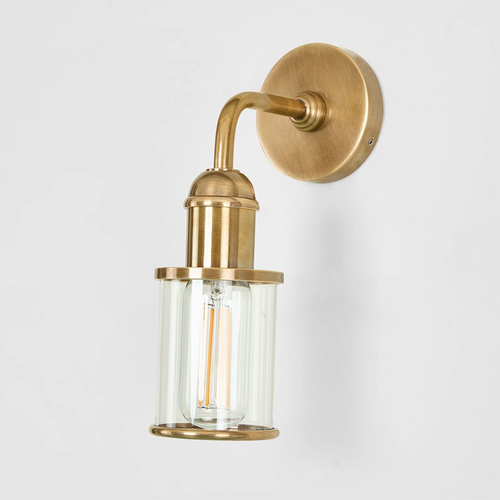Serenity Wall Light in antique brass – minimalist wall sconce with clear glass cylinder for modern and classic interiors