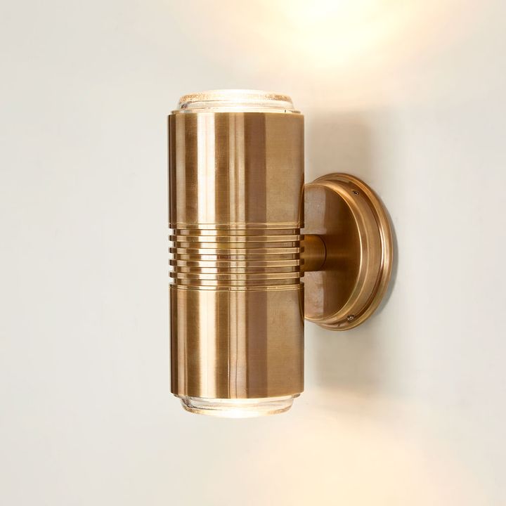 Primrose Outdoor Light in solid brass and glass – modern minimalist wall light with dual-beam illumination for entryways, patios, and interiors