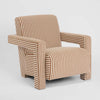 Art Deco inspired upholstered armchair with structured arms and sculptural silhouette for modern interiors