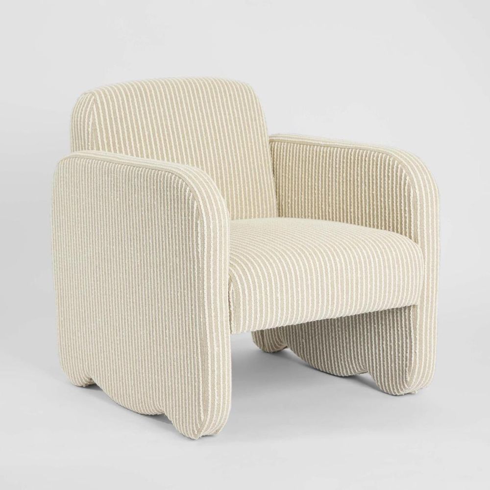 Sculpted lounge chair with scalloped base and striped upholstery for modern living room seating