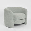 Cora curved armchair with high back circular design and upholstered seat for modern living room seating