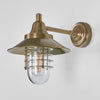 Clark Wall Light IP54 solid brass with clear glass and metal cage – industrial outdoor wall sconce for patios, entryways, gardens, and bathroom lighting