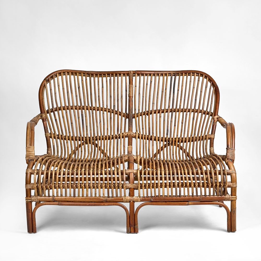 Seville rattan armchair with hand woven frame, high back design, and curved silhouette for indoor or sheltered outdoor use