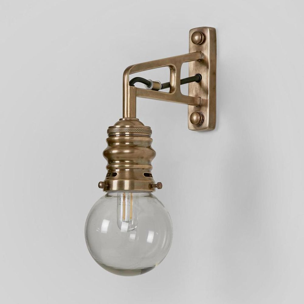 Carlton Outdoor Wall Light antique brass with clear glass shade and curved arm – traditional solid brass outdoor wall sconce for entryways, patios, and porches